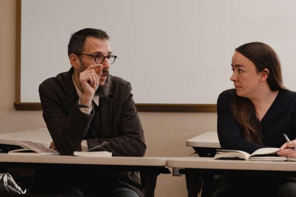 A teacher in a seminar class with a student